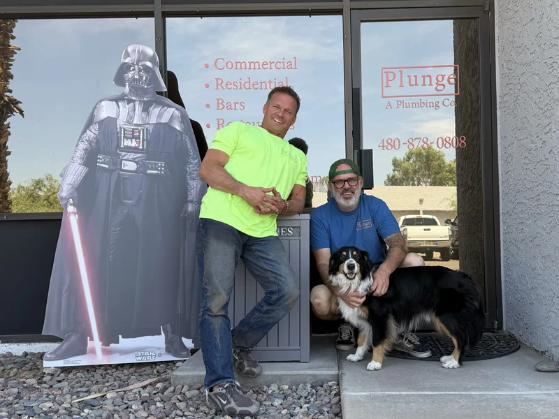 The two owners of Plunge and their dog in front of the Plunge shop