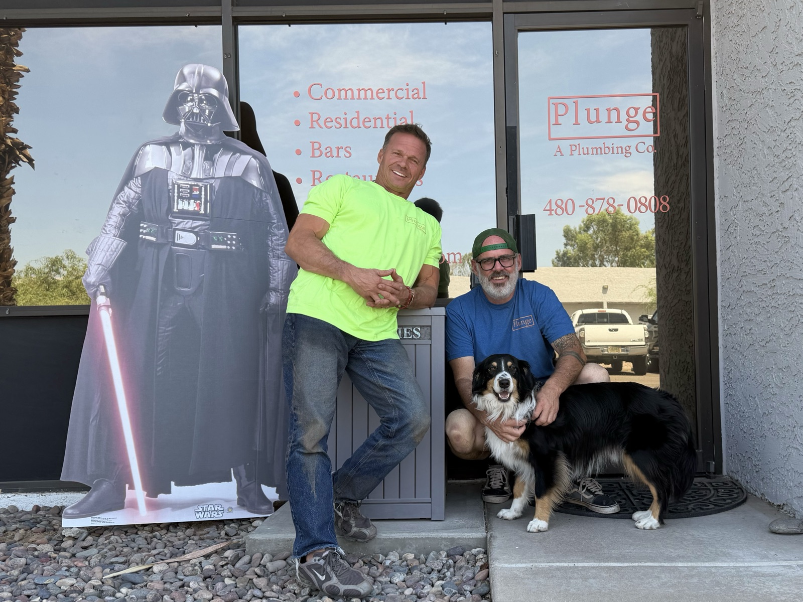 The two owners of Plunge and their dog in front of the Plunge shop