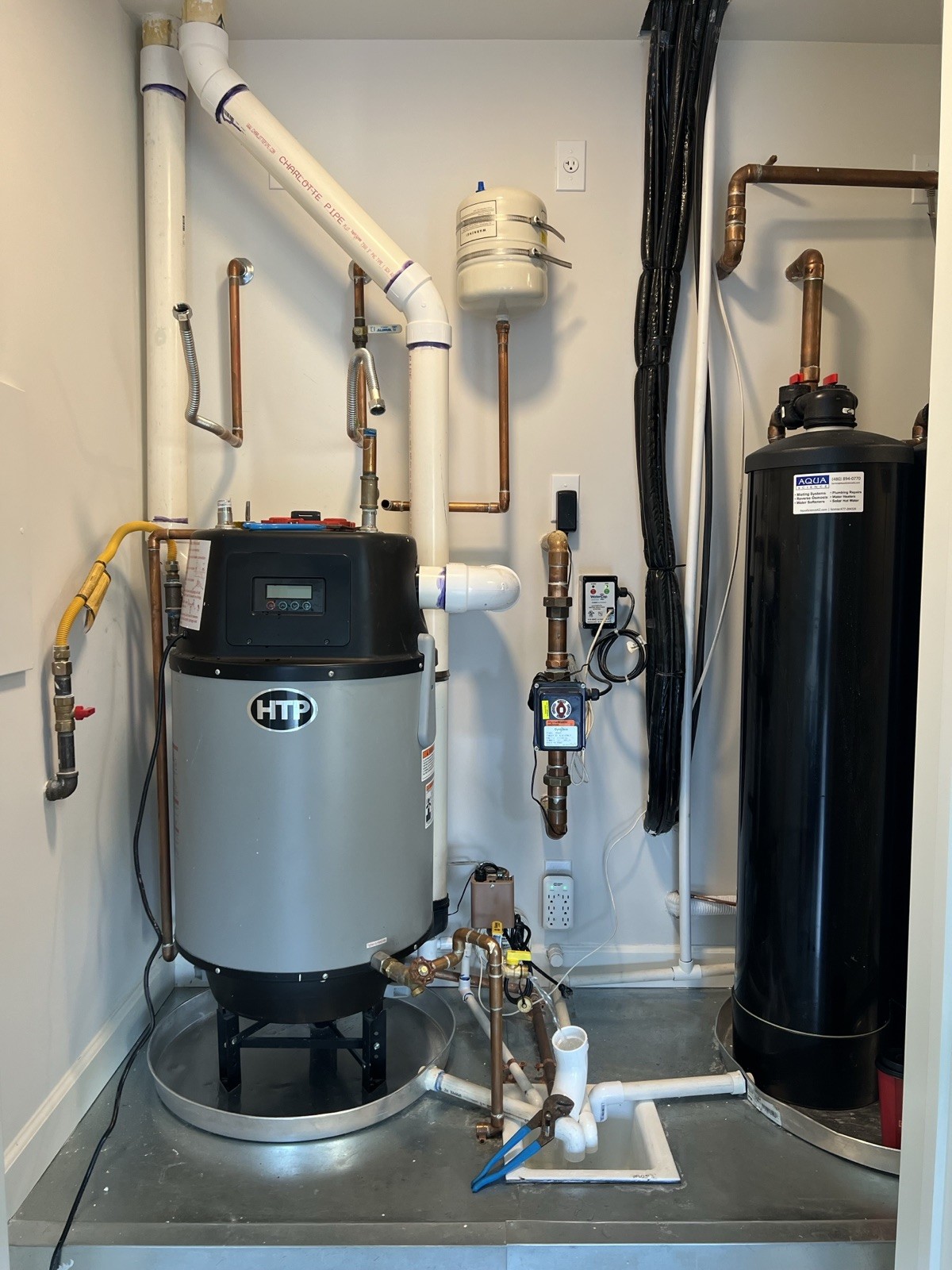 Hybrid water heater and water softener filling a utility closet before the upgrade